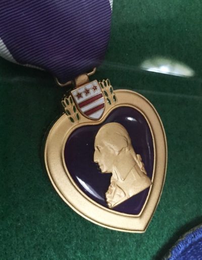 The purple heart awarded to Charles Holcomb for his service during WWII.