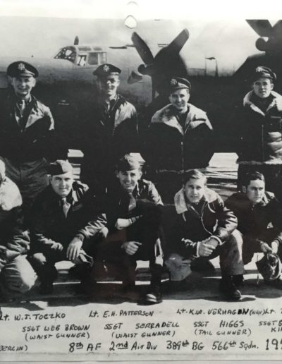 Charles Holcomb, bottom row far right, with his crew in front of a B-24 bomber in a photo from 1944.