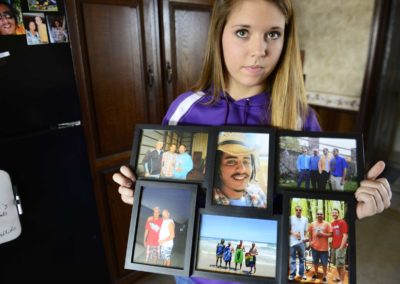 Bralyn Gregg, 15, of Clyde holds family photos featuring her brother, Bryce Williamson, who died of a drug overdose.