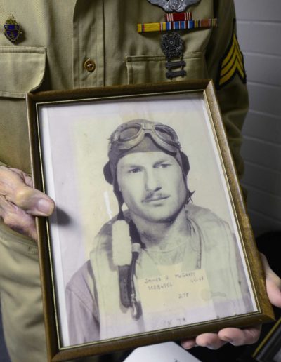 Jim McGrady holds a picture of himself from 1944 when he used to fly a B-24 Bomber.