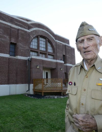 Jim McGrady stands in front of the Old Armory in Fremont where he trained for his service.