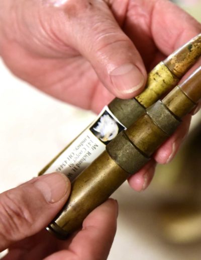 Willer holds bullets from a .50 Caliber Machine Gun, which he fired before assigned to the howitzer.